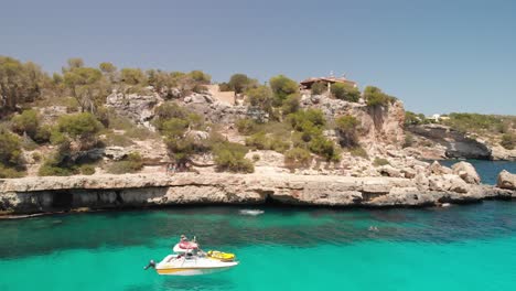 Spain-Mallorca-Cala-Llombards-and-Cala-Santanyi-at-4k-24fps-with-ND-filters-flying-with-a-DJI-Mavic-Air-with-beautiful-views-of-the-beaches,-rocks,-boats-and-blue-water