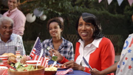 Two-young-black-boys-stand-to-entertain-family-at-a-barbecue