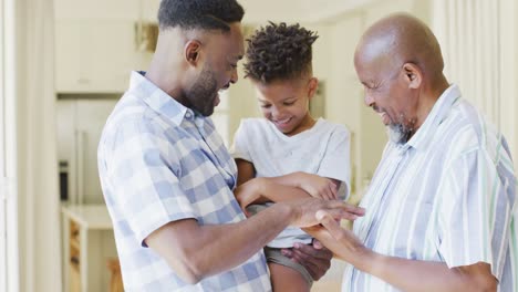 Happy-african-american-son,-father-and-grandfather-laughing,-slow-motion