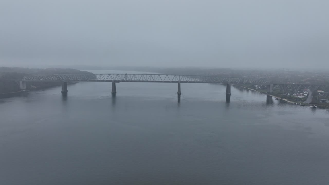 The Old Little Belt Bridge, betwen Snoghoj and Middlefart, rail road bridge. foggy weather. Aerial view.