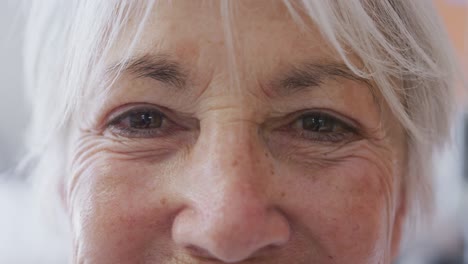 portrait of happy senior caucasian woman smiling and looking at camera at hospital