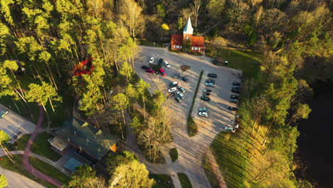 Top-Down-View-of-Parking-Lot-and-Church-in-Valmiera,-Latvia-near-Janis-Dalins-Stadium