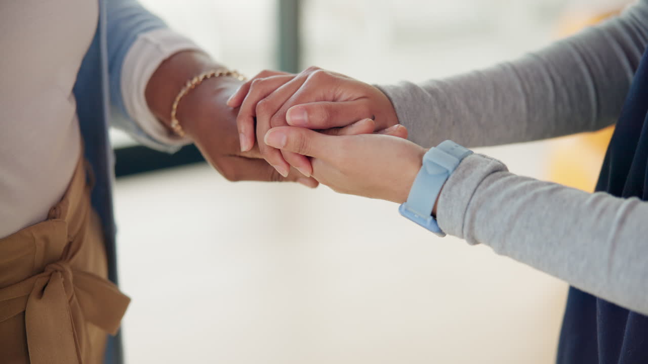 Close Up of Two People Gently Holding Hands