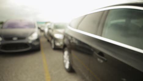 Panning-shot-of-a-line-of-parked-cars-with-a-shallow-focus-and-a-blurry-background