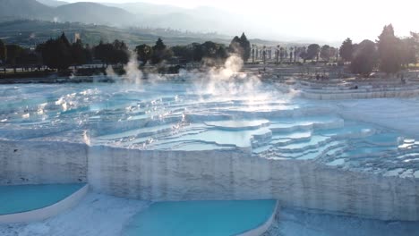 Steamy-blue-hot-springs,-mineral-waters,-forming-travertine-limestone-mineral-deposit-formations