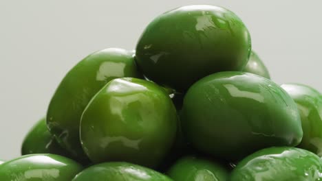 pickled round green olives from greece as background, top view. high quality 4k footage