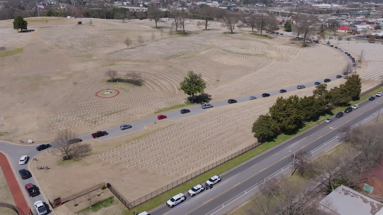 Aerial footage following a funeral procession as it moves through Chattanooga National Cemetery.