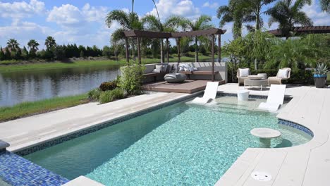 beautiful new pool installation with pergola, spa, built-in features, and natural gas fireplace