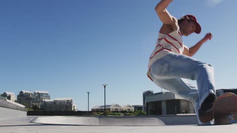 Caucasian-man-riding-and-jumping-on-skateboard-on-sunny-day