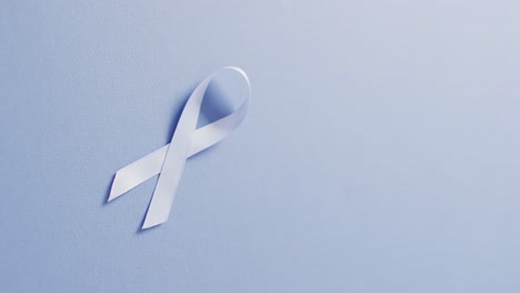 video of pale blue prostate cancer ribbon on pale blue background