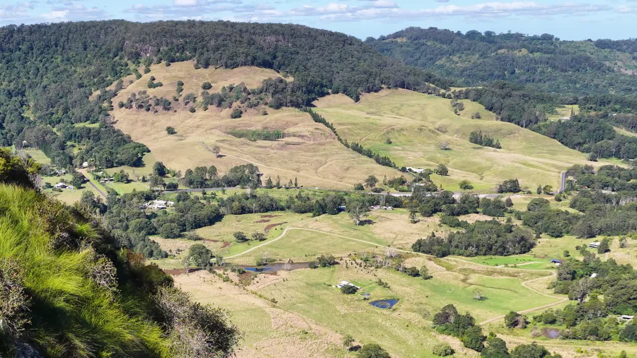 Panoramic view of lush green hills and valleys under bright daylight in Nimbin, NSW, Australia