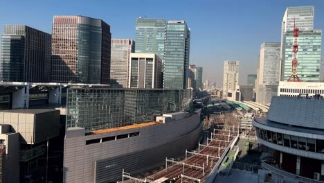 Clear-day-view-of-modern-cityscape-with-skyscrapers,-urban-architecture,-and-train-tracks,-no-people-visible,-static-shot