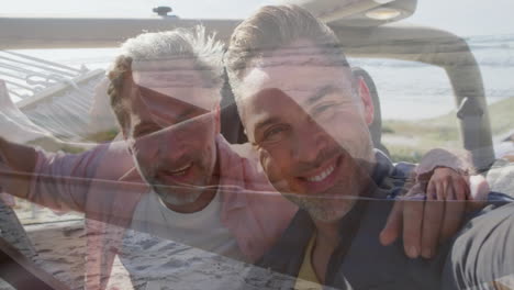 embracing and smiling, two men enjoying animation on beach scene