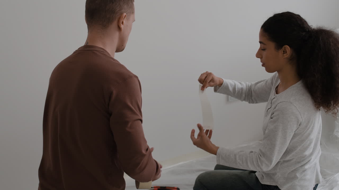 Couple Preparing Walls for Painting