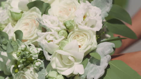 woman bride holds gorgeous wedding bouquet of white roses