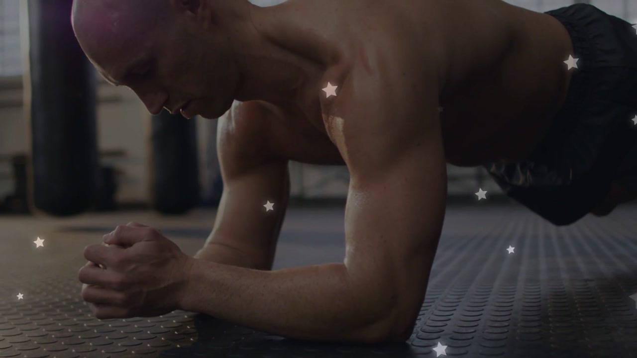 Man starting forearm plank on mat, tensing core for fitness, shifting, stars drifting over arms