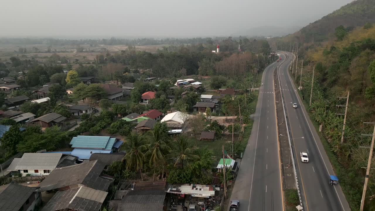 Aerial view of a highway traversing a rural village landscape