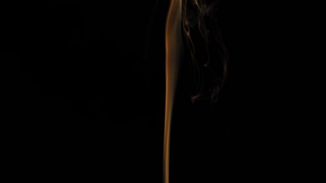 stream of orange smoke on black background rises up.