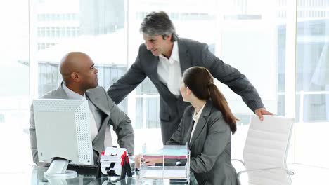 confident business partners working at a computer