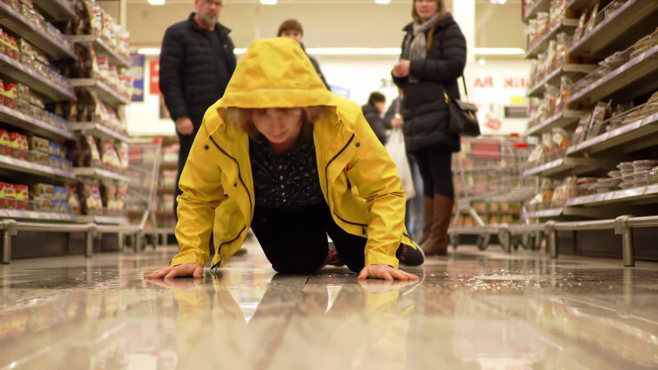 A Dramatic Moment in the Grocery Store: A Woman in a Yellow Jacket Falls to the Floor Amidst Busy Shoppers and Reflective Surfaces