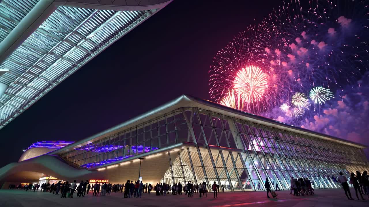 Fireworks Display Over Modern Building at Night