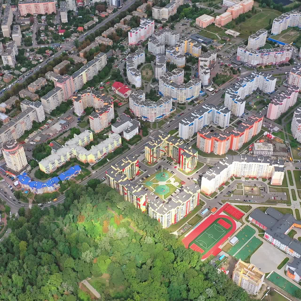 Urban landscape with green plantings. High-rise housing apartments of a new residential complex in modern city district. Aerial view