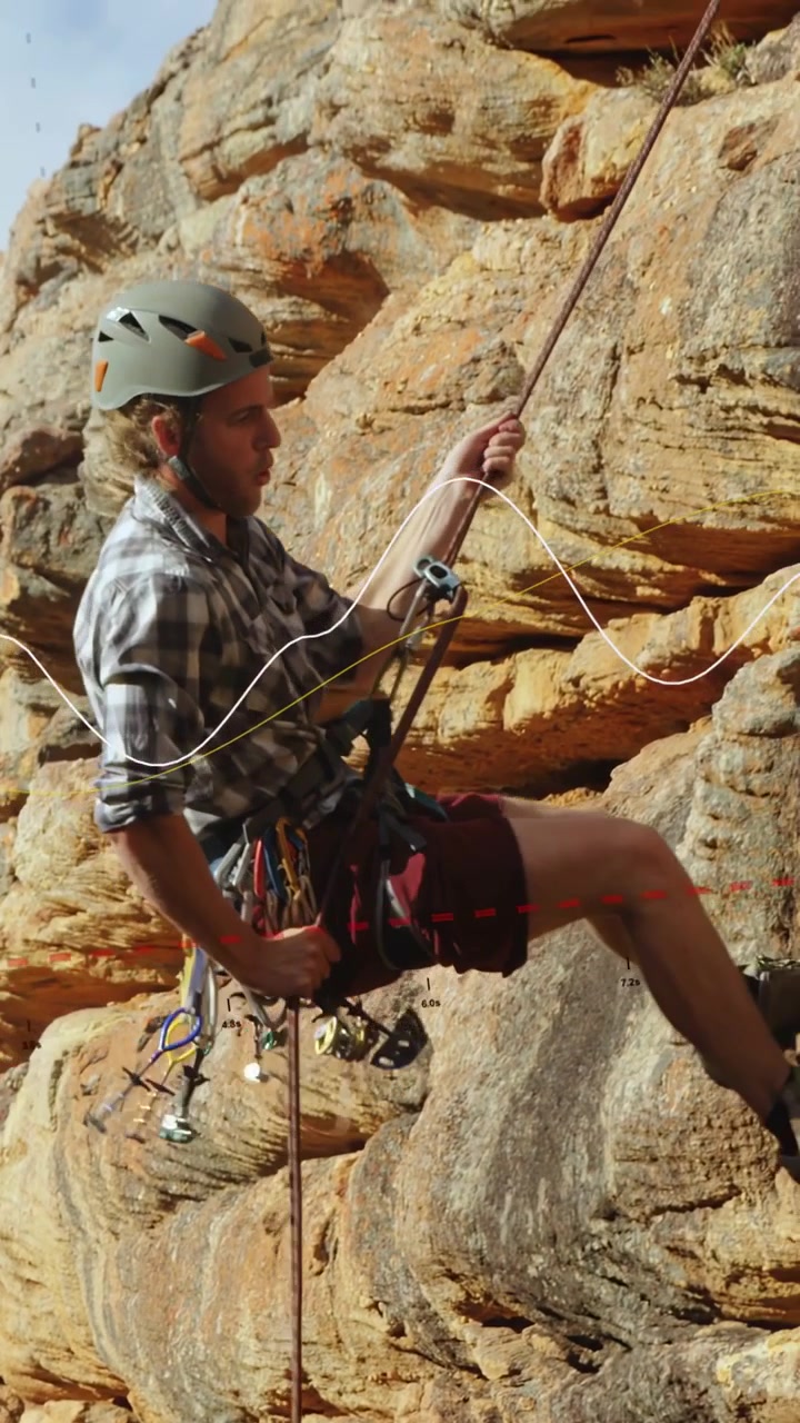 Vertical video: Climber adjusting gear then sliding rope to find holds on cliff for sports