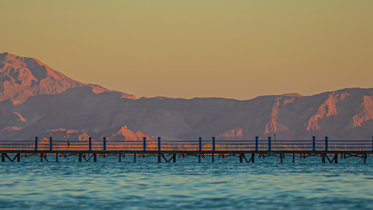 Time lapse Red sea Sinai Mountains pier over water day to night transition