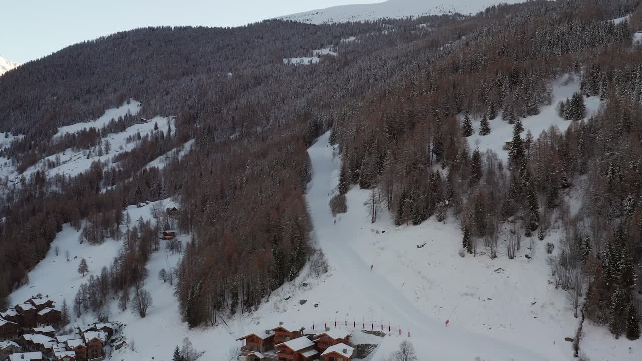 Aerial view of the ski slopes before season opening during sunset. Going towards the slopes