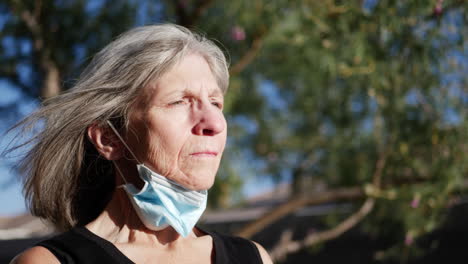 An-aging-elderly-woman-patient-with-a-hospital-mask-breathing-fresh-air-into-her-lungs-after-a-treatment-for-her-sickness