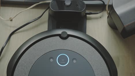 a robot vacuum returning to its charging station - close up