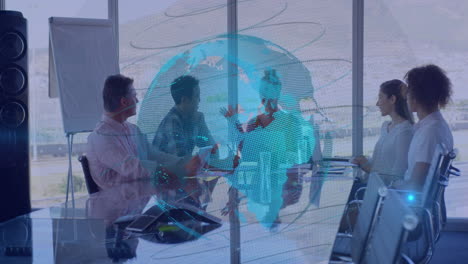 animation of spinning globe against group of diverse businesspeople discussing together at office