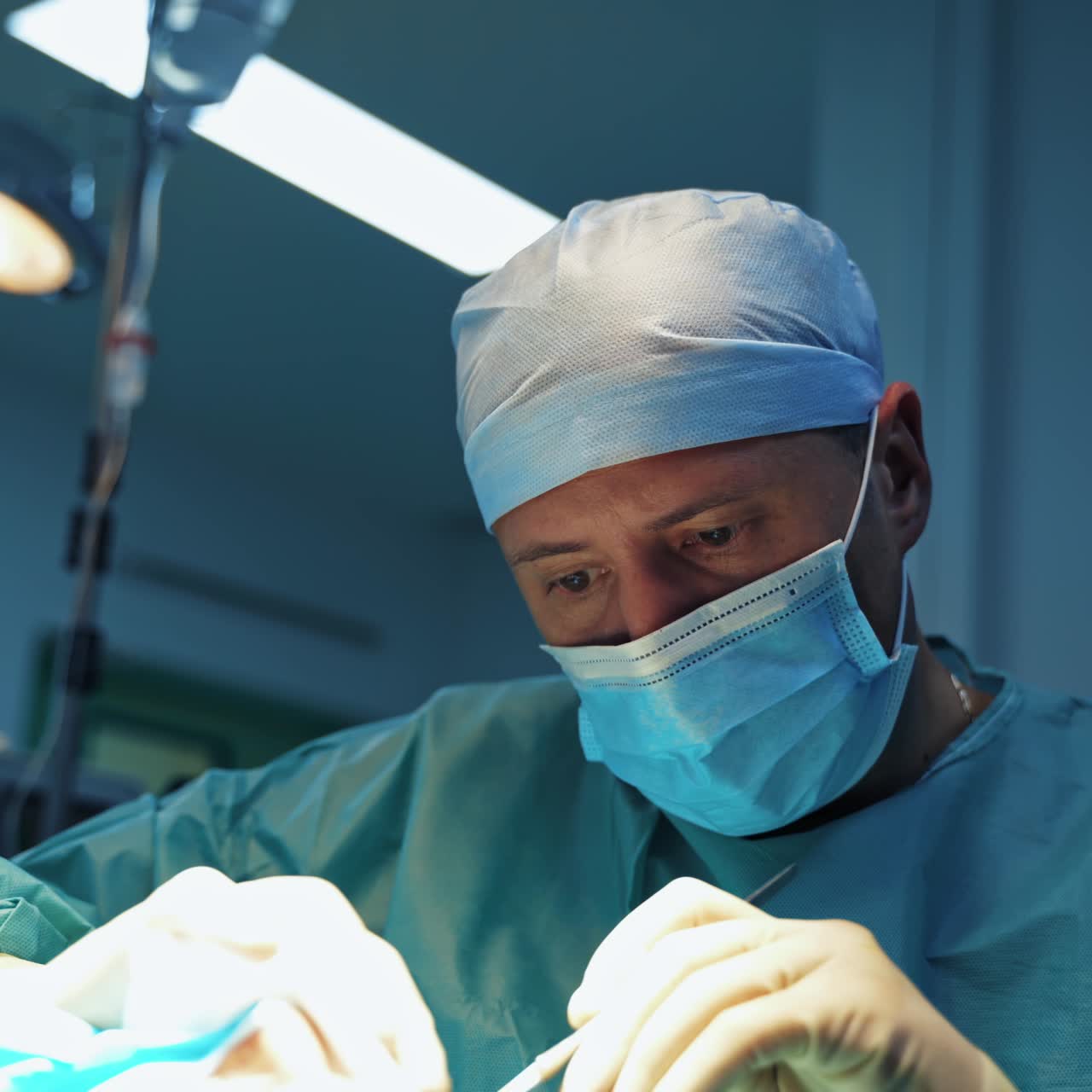 Male surgeon operates a patient in the operating room. Blepharoplasty plastic surgery operation for modifying the eye region of the face in medical clinic.