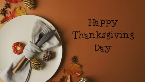 animation of happy thanksgiving text and cutlery and pine cones over brown background