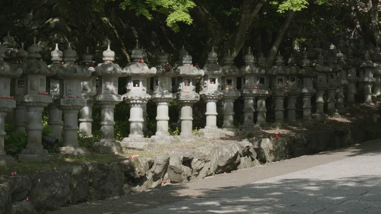 Stone statues with red daruma dolls in Katsuoji Temple, Osaka, Japan