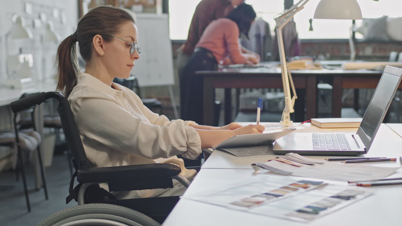 Female Fashion Designer in Wheelchair Working