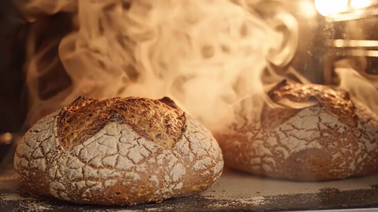 Freshly Baked Artisan Bread Rising in the Oven: Captivating Aroma and Beautiful Crust Creating a Perfect Golden Loaf Moment