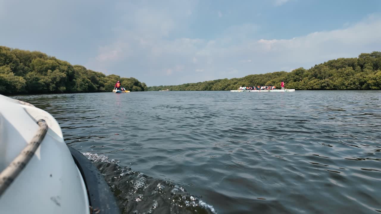 Kayakers exploring the peaceful waters of Al Zorah Mangrove in Ajman, UAE.