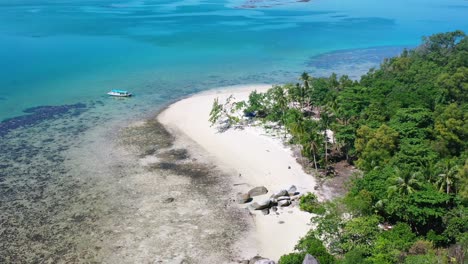 aerial of white sand beach with large boulder rocks in belitung indonesia