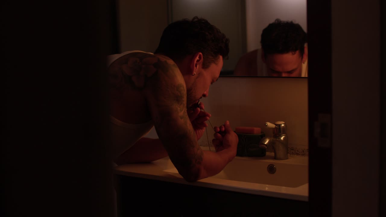 Man Grooming in Bathroom with Tattoo