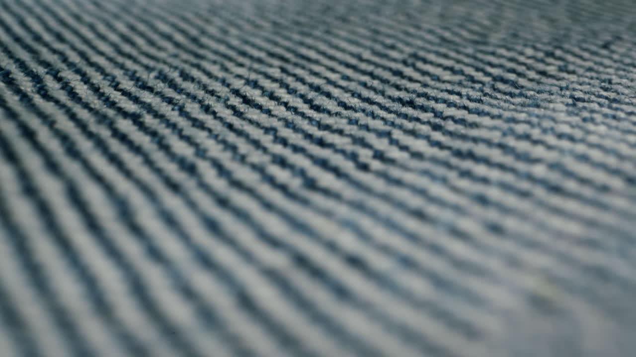 Blue textile jeans cloth texture close-up macro. Fashion fabric multicolor. Cotton casual clothes