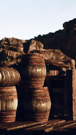 stacked wooden barrels in a western setting