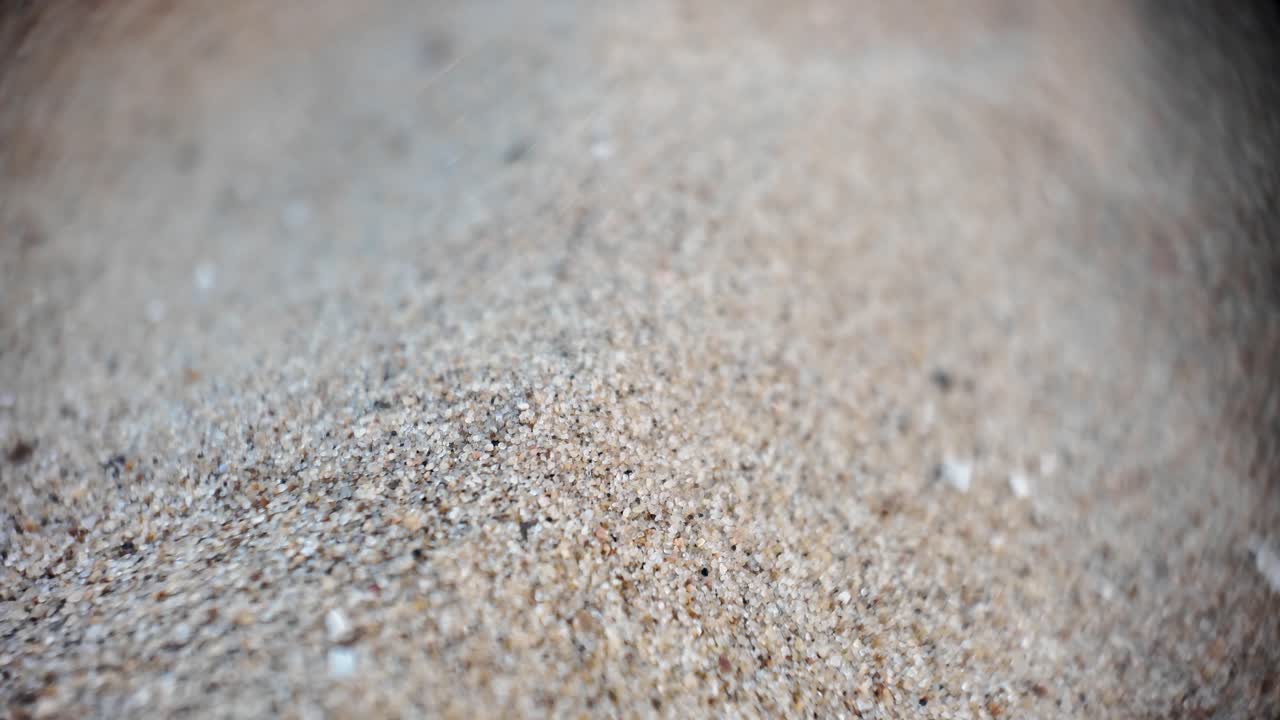 Macro view of fine sand grains showcasing intricate textures and earthy tones