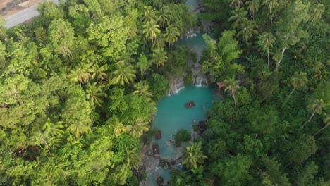 Flying-above-the-Cambugahay-Falls-at-siquijor-at-the-Philippines-with-a-drone-on-a-sunny-morning-Cinematic-Drone-Aerial-in-4K