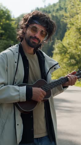 man playing ukulele outdoors