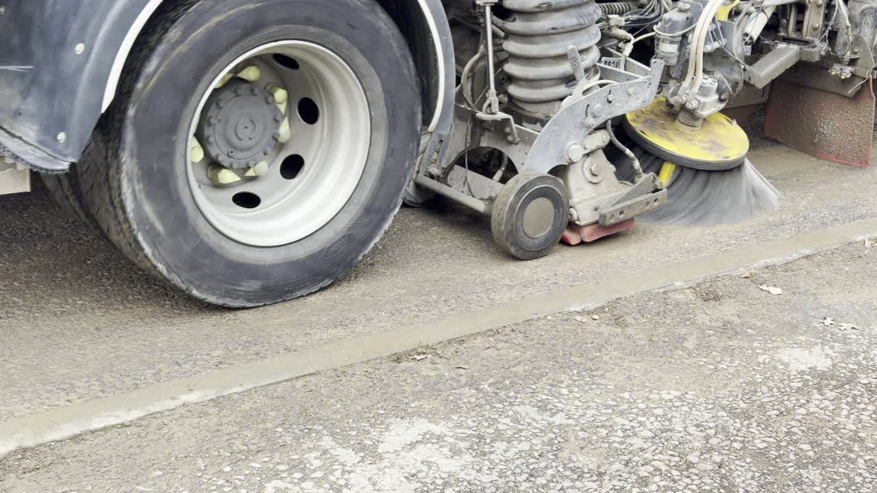 Road sweeper truck cleaning the road ahead of new tarmac work