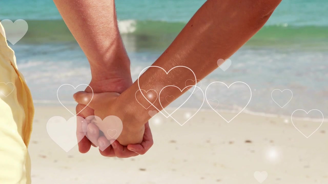 Hearts appearing, starting joined hands holding, fingers settling, surf moving, evoking calm love