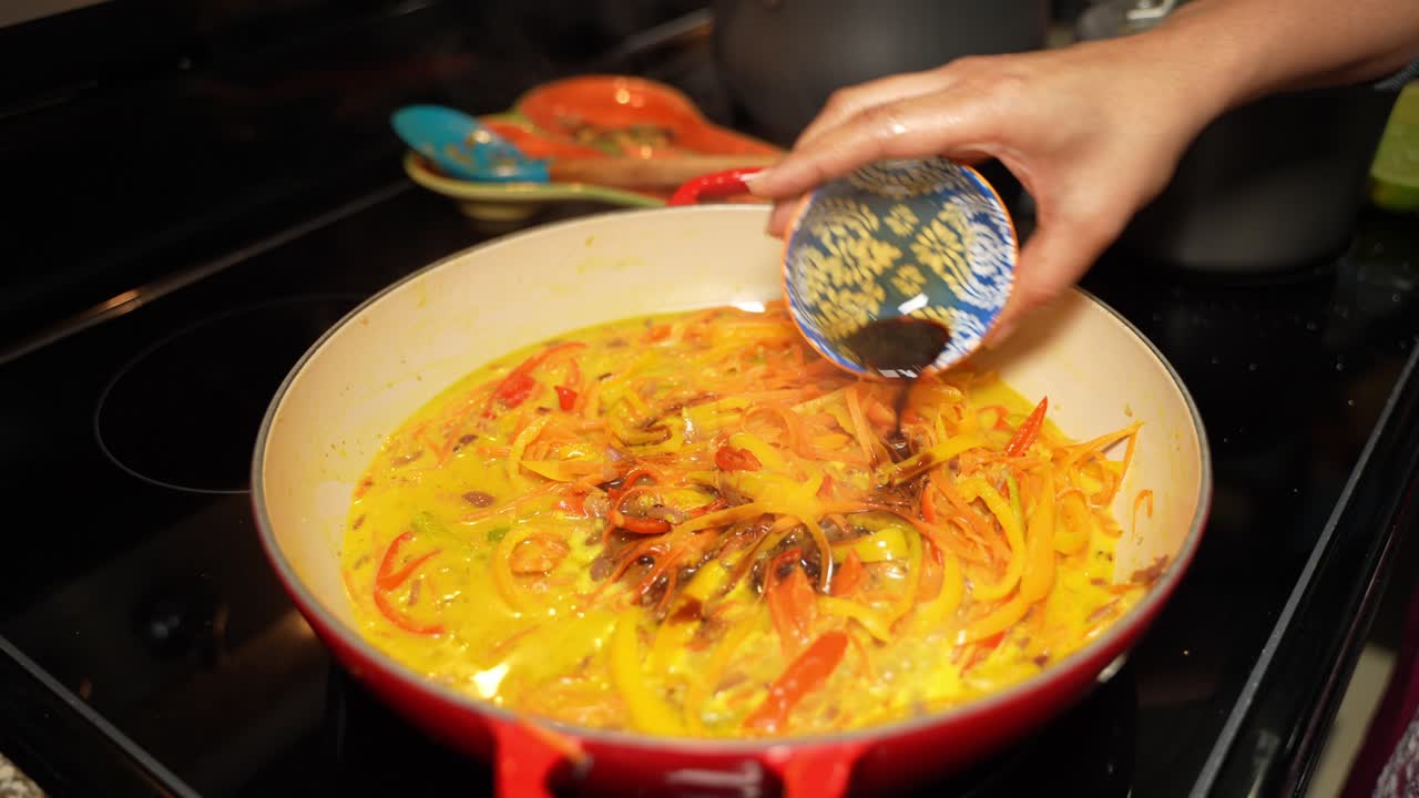 Using of soy sauce in slices of bell papers for enhancing the taste in frying pan.