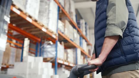 Adult-caucasian-man-working-pushing-forklift-in-a-warehouse.