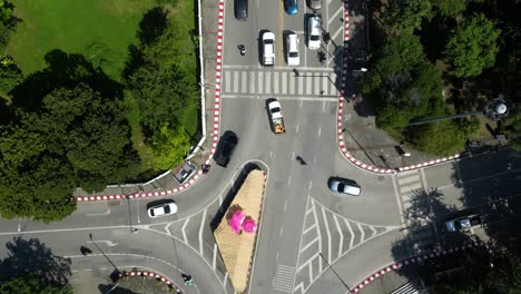 aerial forward flight looking down on busy intersection with cars